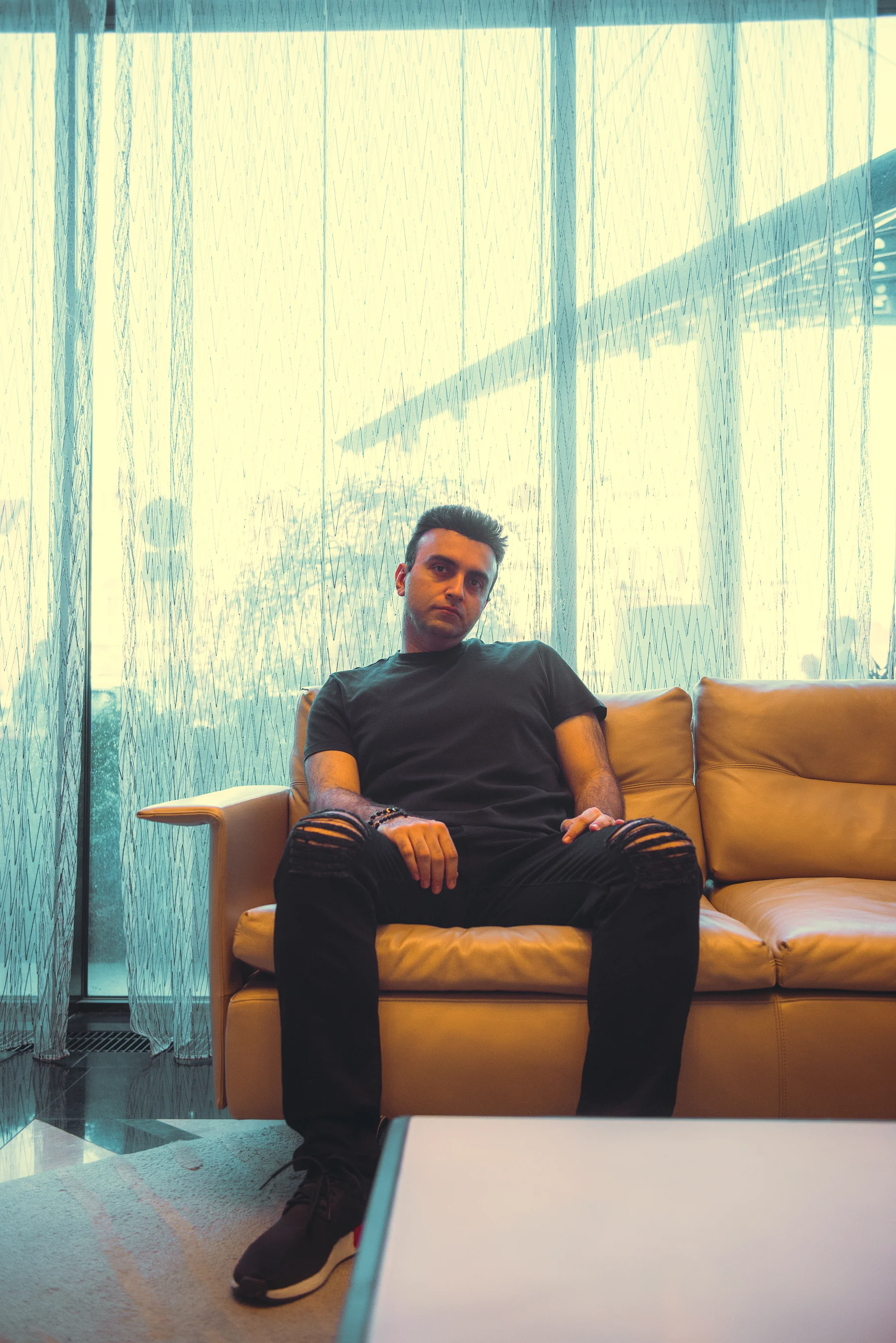 Taha Asadi sitting by a window